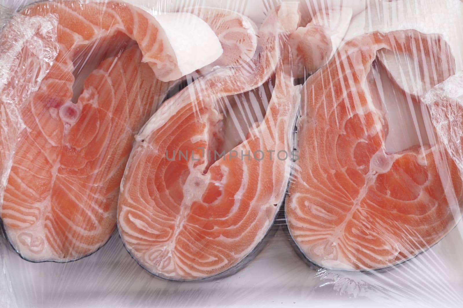 Indulge in vacuumsealed salmon fillets infused with fresh garlic and vibrant cherry tomatoes