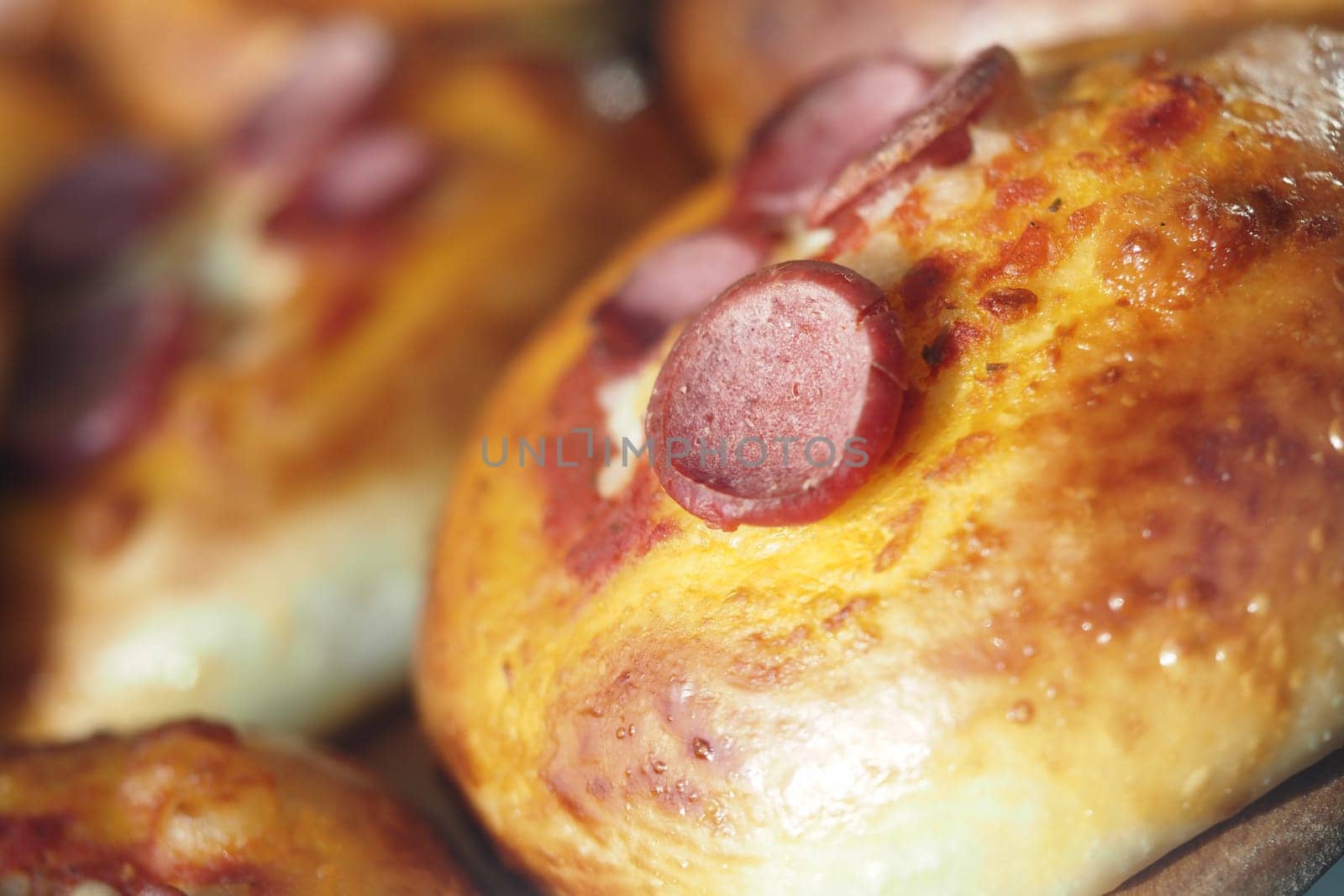 These warm baked buns filled with savory sausage slices are perfect for delightful snacks