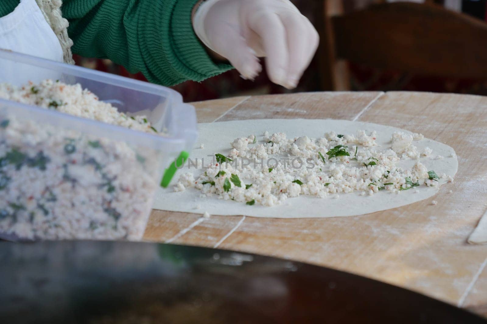 A skilled hand expertly prepares premium dough with fresh ingredients for delicious treats
