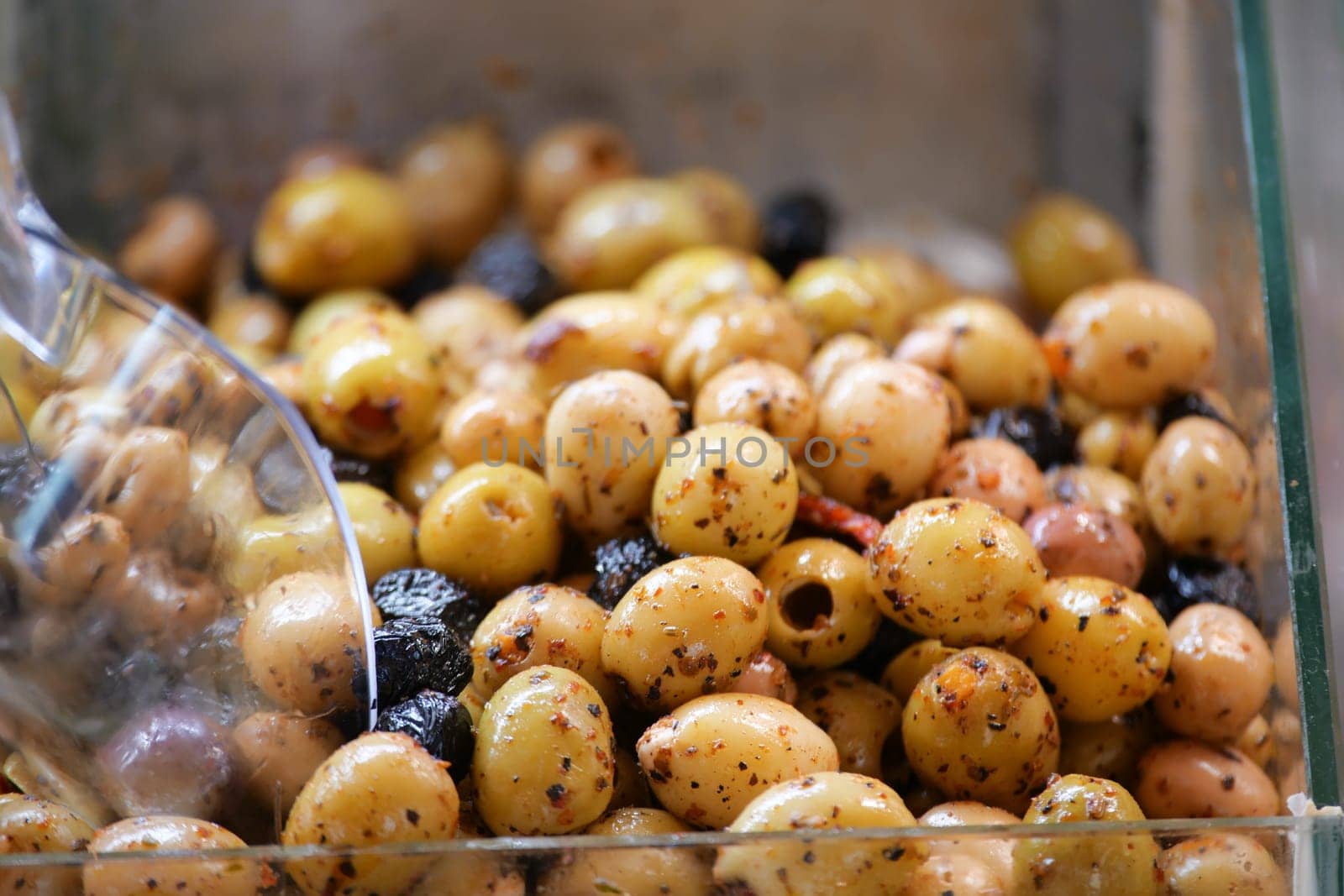 These marinated olives are now ready for serving in a clear container, inviting all to enjoy