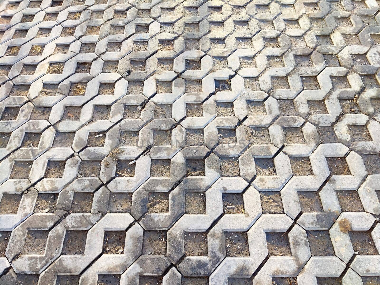 Geometric pavement features a unique hexagon pattern made of concrete blocks, providing a textured backdrop with space for additional design elements.