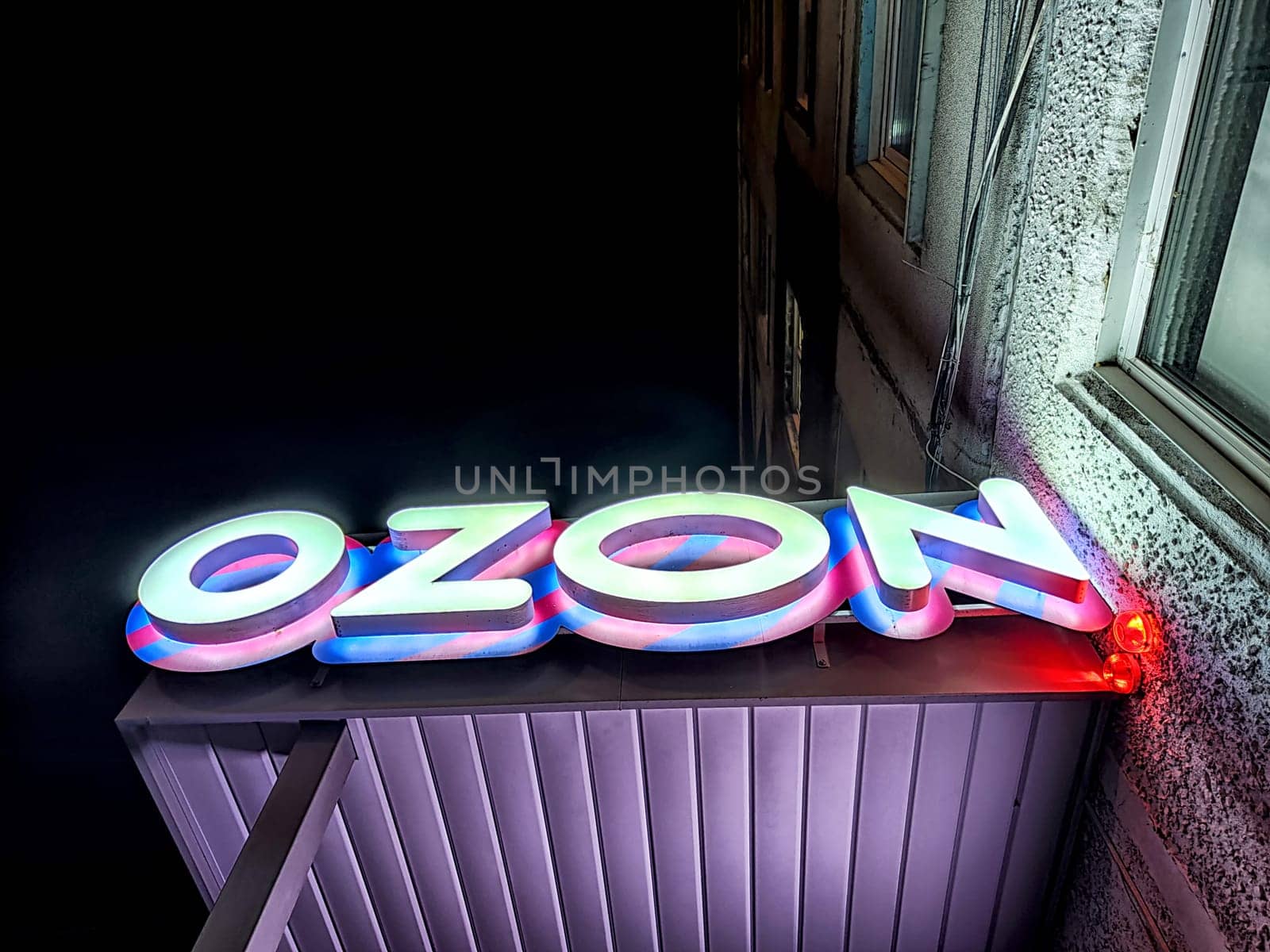 Krasnoyarsk, Russia - November 06, 2024: Vibrant illuminated logo of an online store shining on a building during nighttime, attracting customers with its glow.
