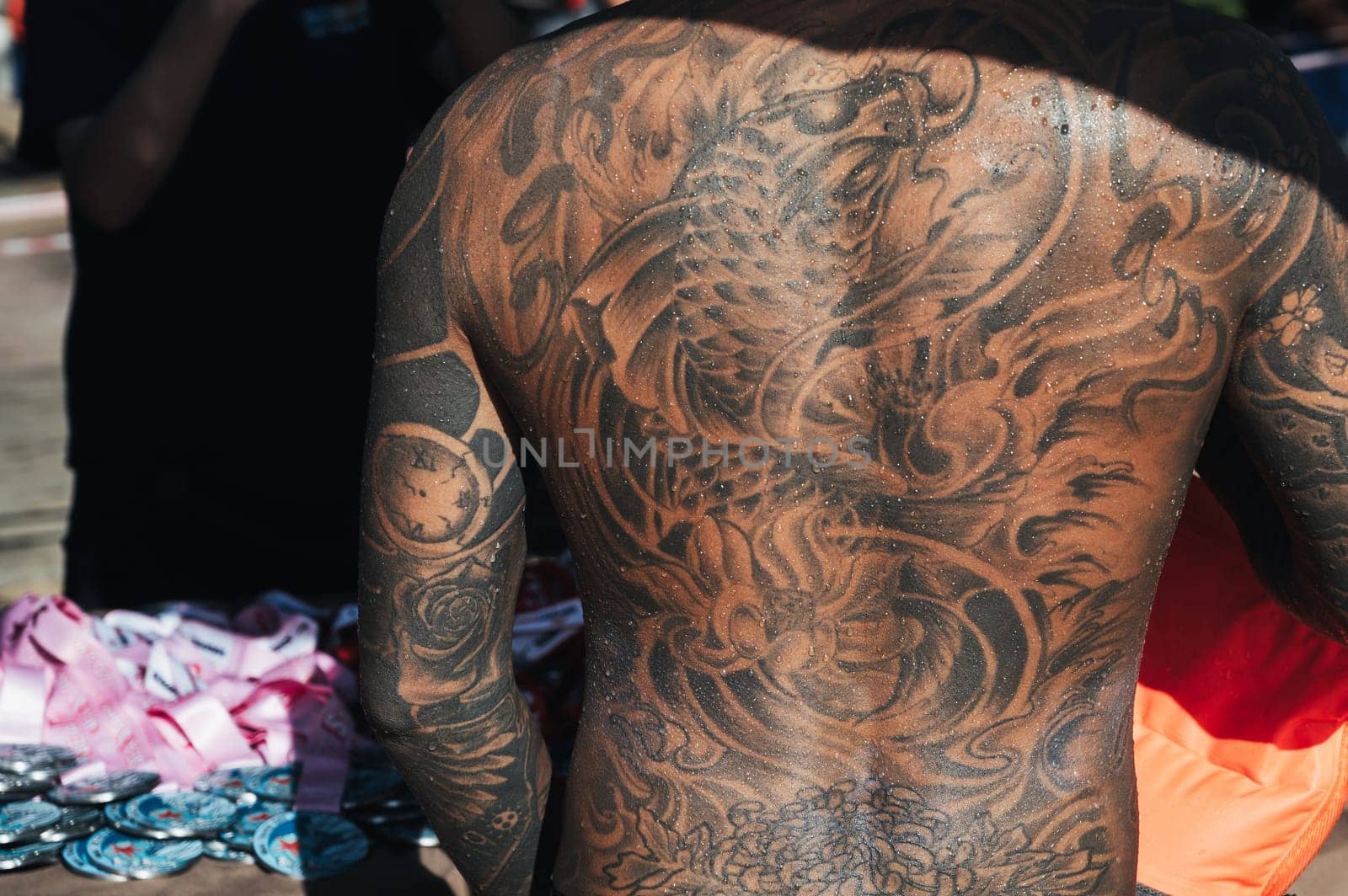A full-back tattoo of one of the male participants of the Sea Star competition in Nha Trang. Nha Trang, Vietnam - July 25, 2024.