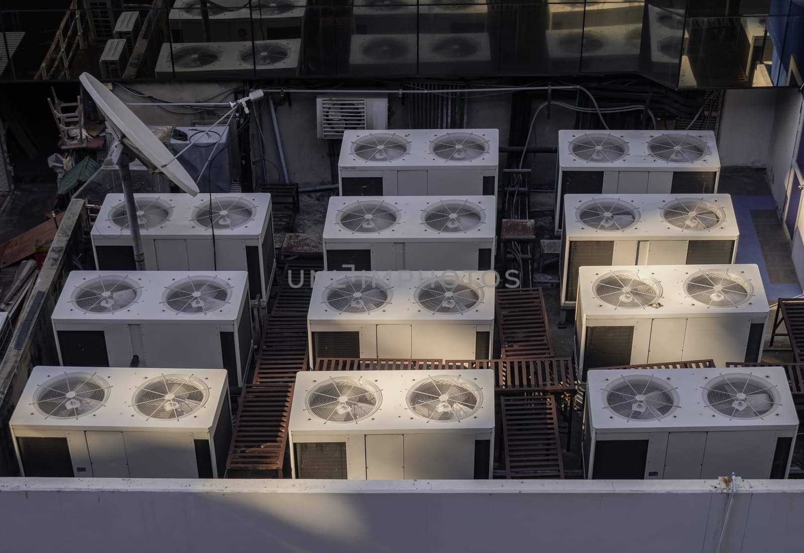 Bangkok, Thailand 23 Dec,2024 - Air conditioner outside unit compressors with fan units. Air conditioning cooling system installed on the rooftop center building, Multiple machines, The heat that floats up into the atmosphere is a lot. use it as your Wallpaper, Poster and Copy space, Selective focus.