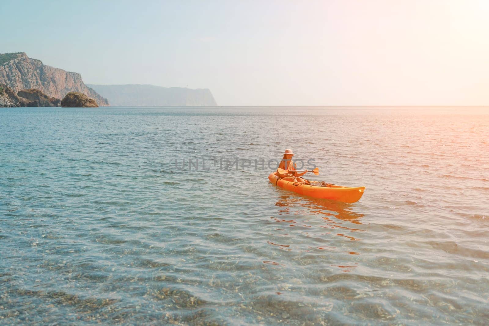 Kayak sea woman. Happy attractive woman with long hair in red swimsuit, swimming on kayak. Summer holiday vacation and travel concept