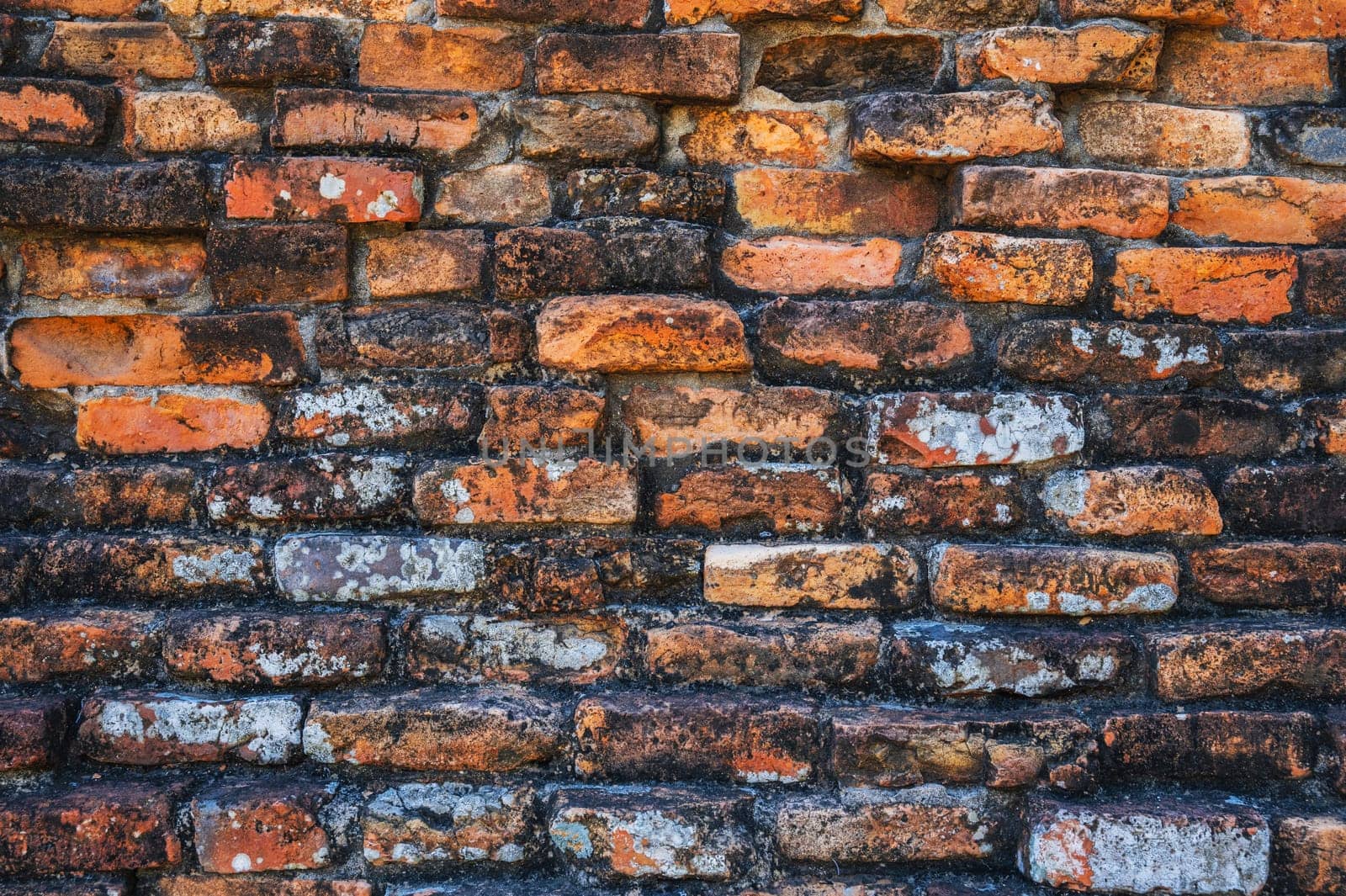texture of the old antique brick wall of an ancient temple in Asia in close-up