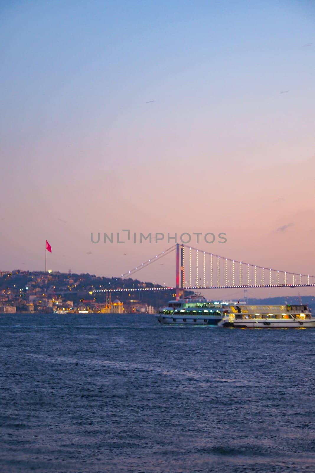 An incredibly serene and picturesque sunset view featuring a beautiful bridge across the calm water