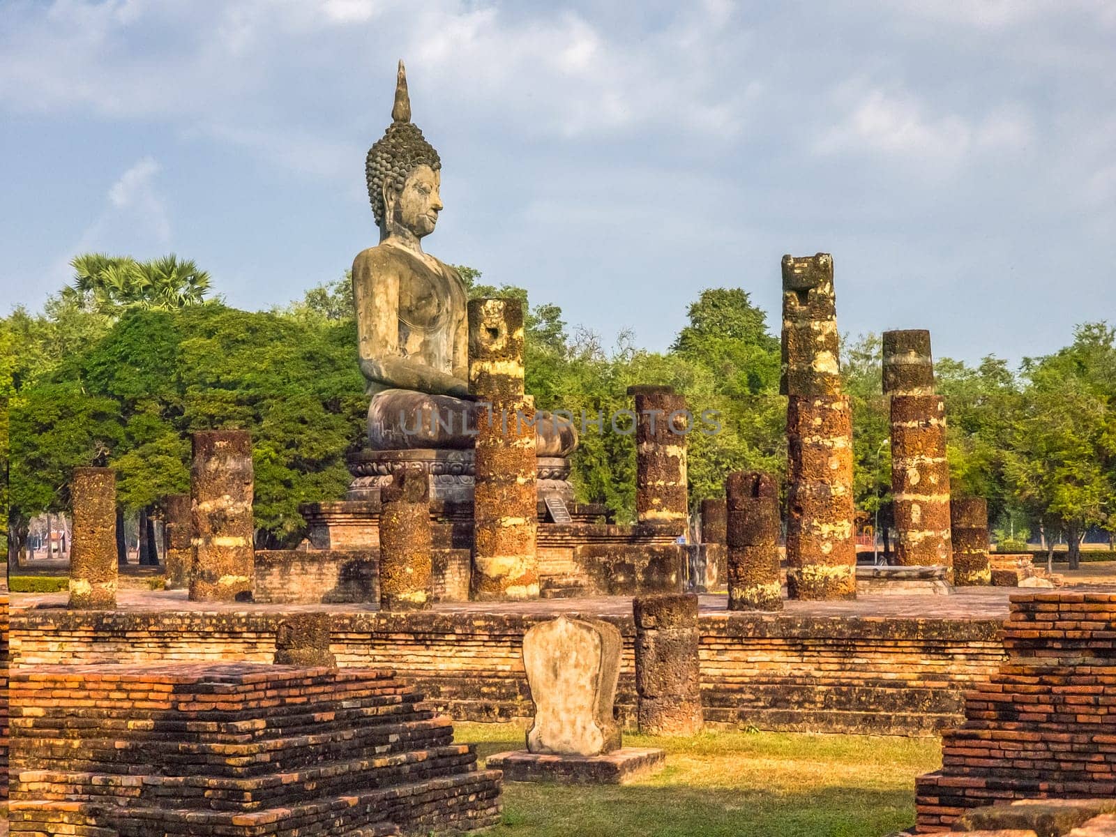 Buddha statue at Wat Mahathat Maha That temple by day, Sukhothai, Thailand