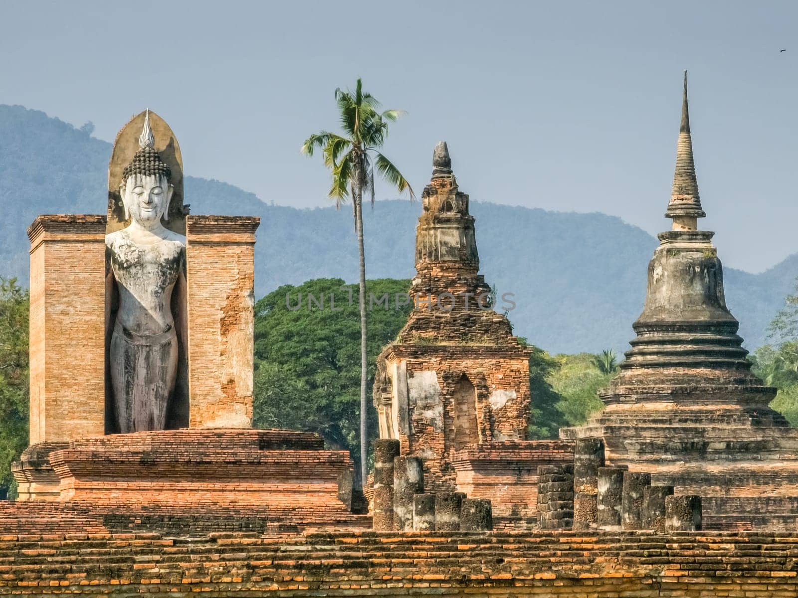 Buddha statue at Wat Mahathat Maha That temple by day, Sukhothai, Thailand