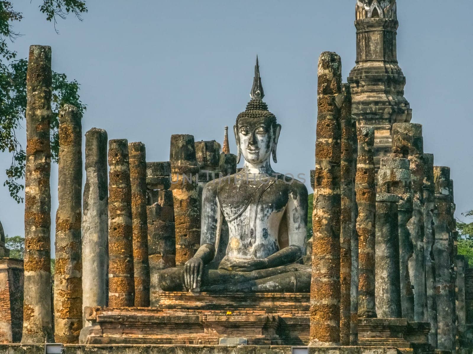 Buddha statue at Wat Mahathat Maha That temple by day, Sukhothai, Thailand