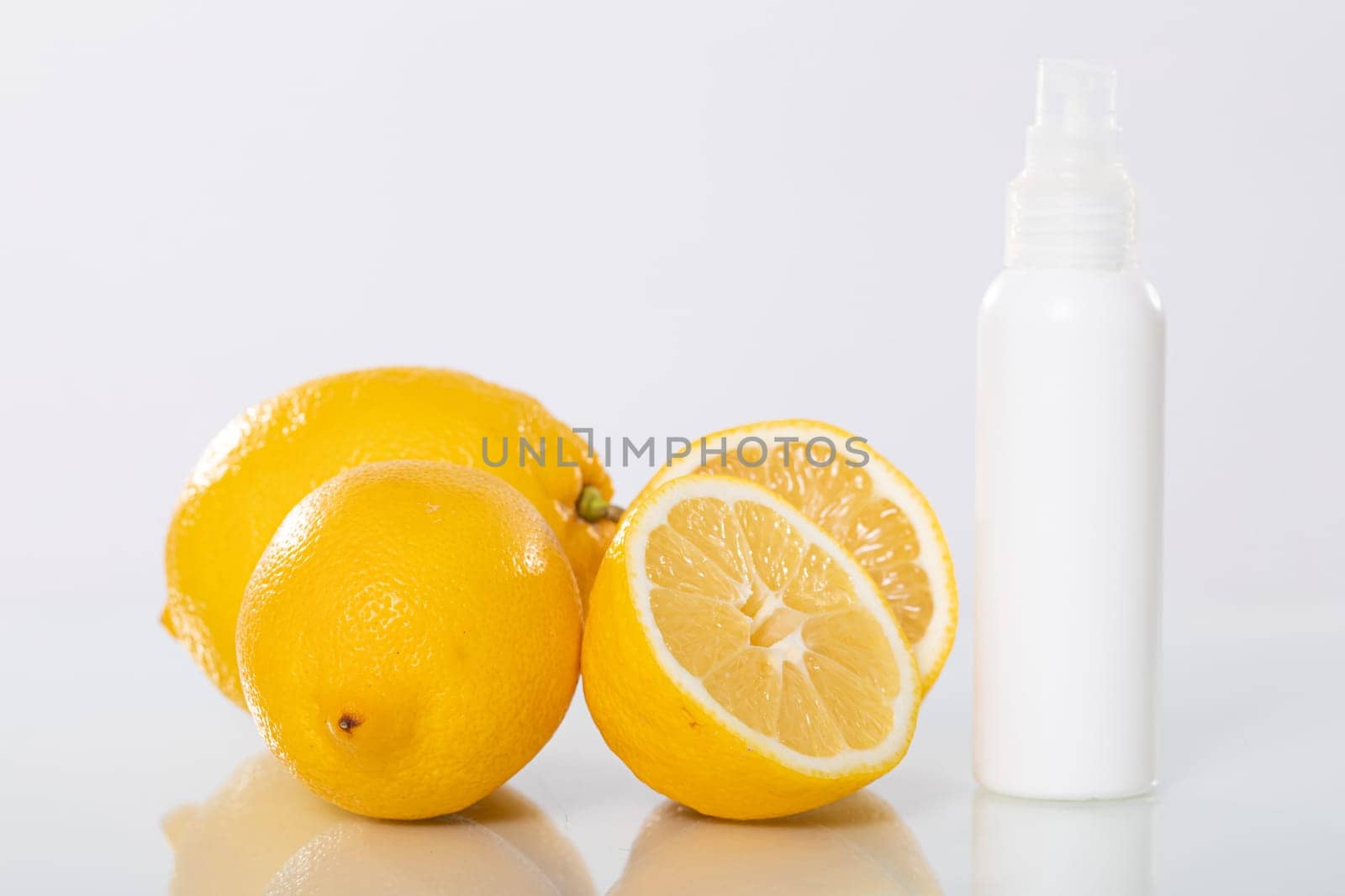 Bright, juicy lemons placed alongside a refreshing citrus spray, offering various health and wellness solutions