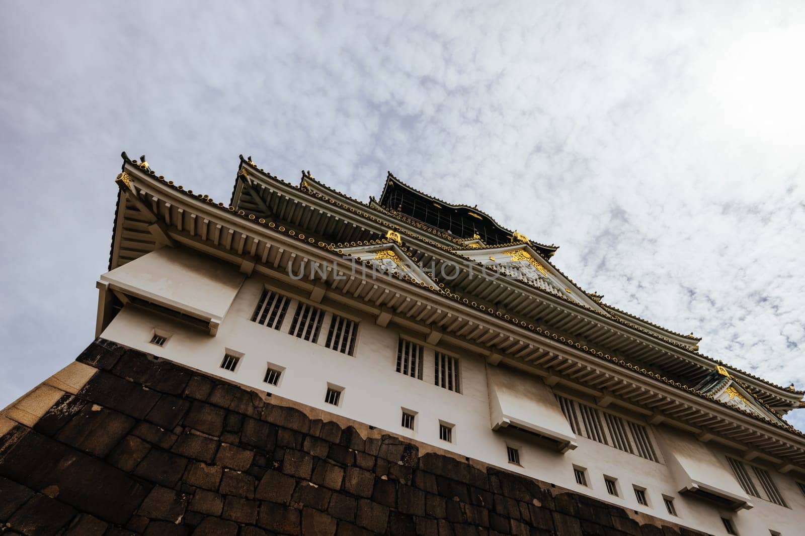 OSAKA, JAPAN - SEPTEMBER 25 2024: The iconic Osaka Castle and lush surrounds on a warm clear autumn day in Osaka, Japan on September 25th 2024
