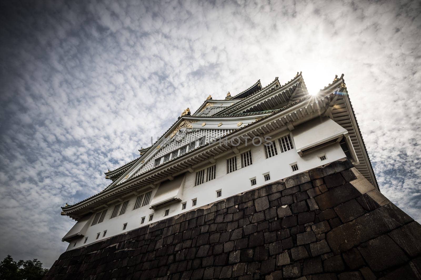 OSAKA, JAPAN - SEPTEMBER 25 2024: The iconic Osaka Castle and lush surrounds on a warm clear autumn day in Osaka, Japan on September 25th 2024
