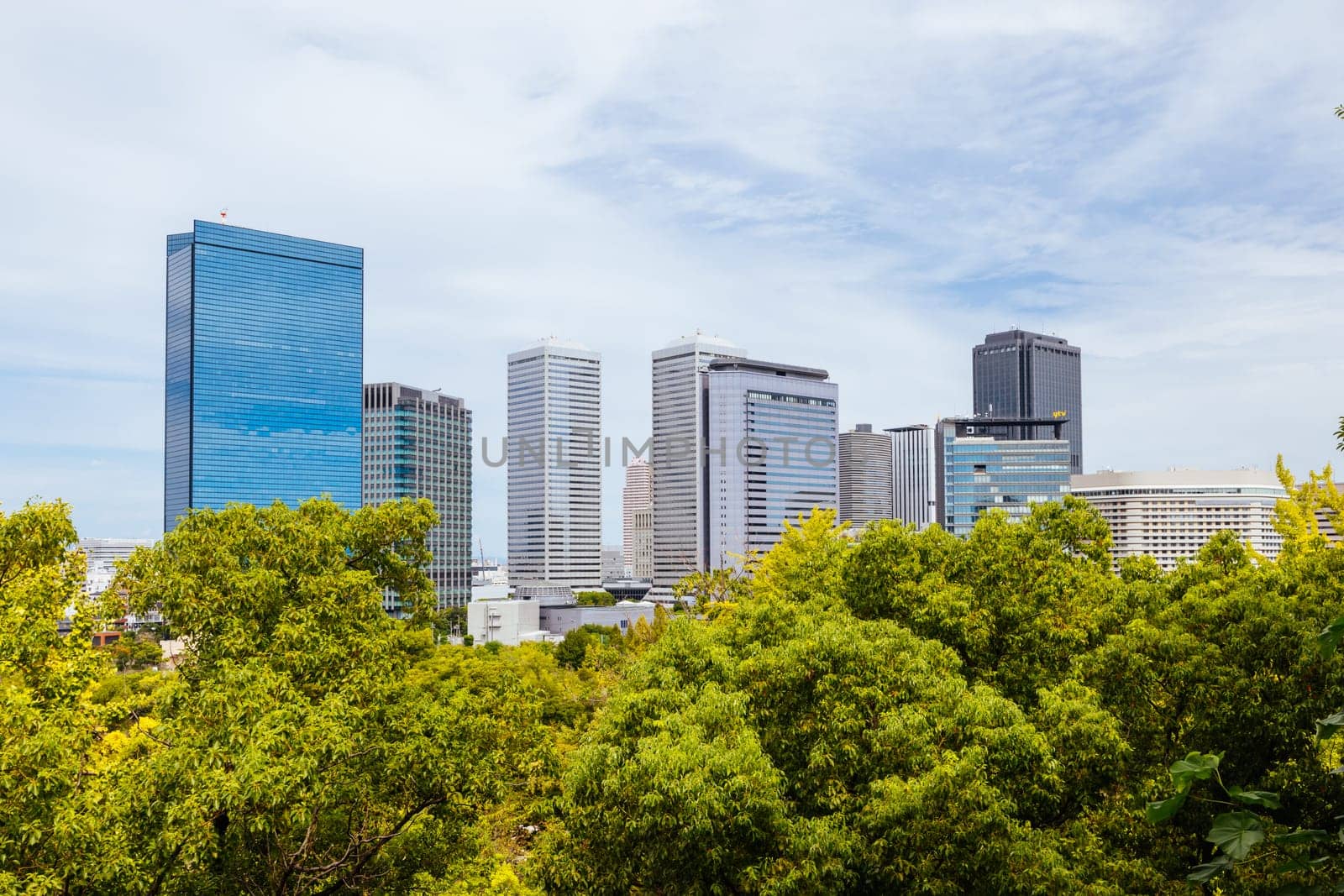 OSAKA, JAPAN - SEPTEMBER 25 2024: Views towards the Shiromi business district and Osaka-Jo Hall from Osaka Castle on a warm autumn day in Osaka, Japan on September 25th 2024