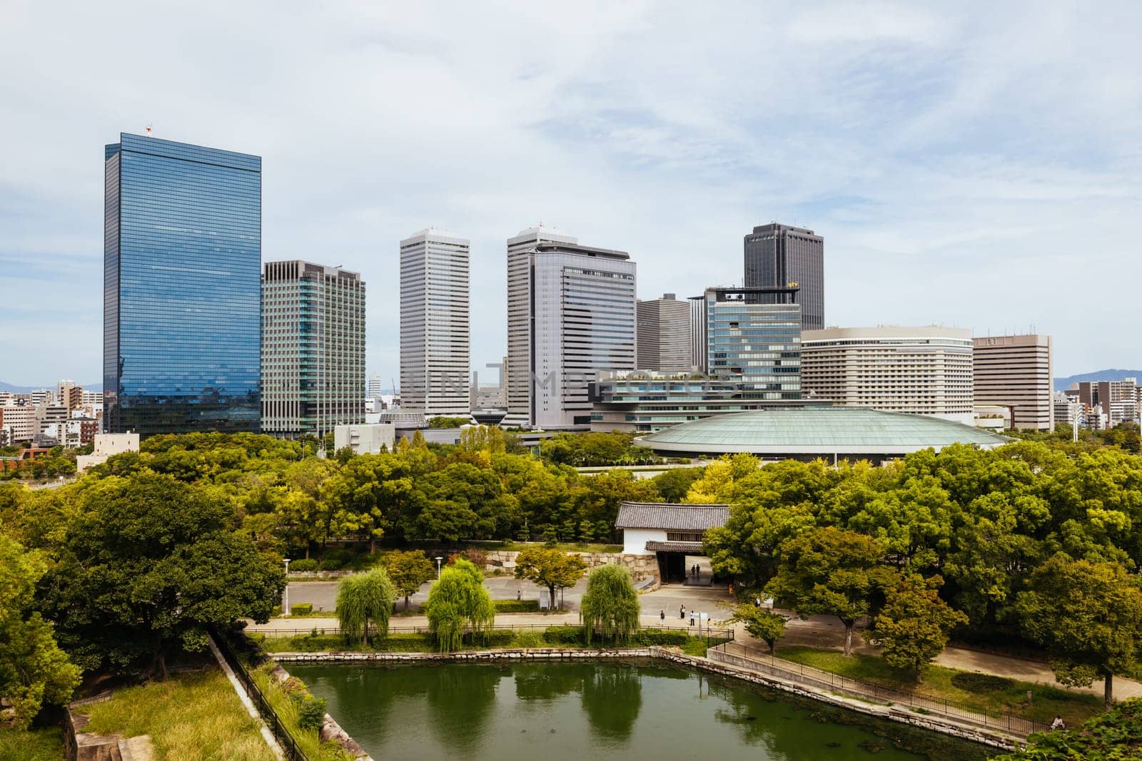 OSAKA, JAPAN - SEPTEMBER 25 2024: Views towards the Shiromi business district and Osaka-Jo Hall from Osaka Castle on a warm autumn day in Osaka, Japan on September 25th 2024