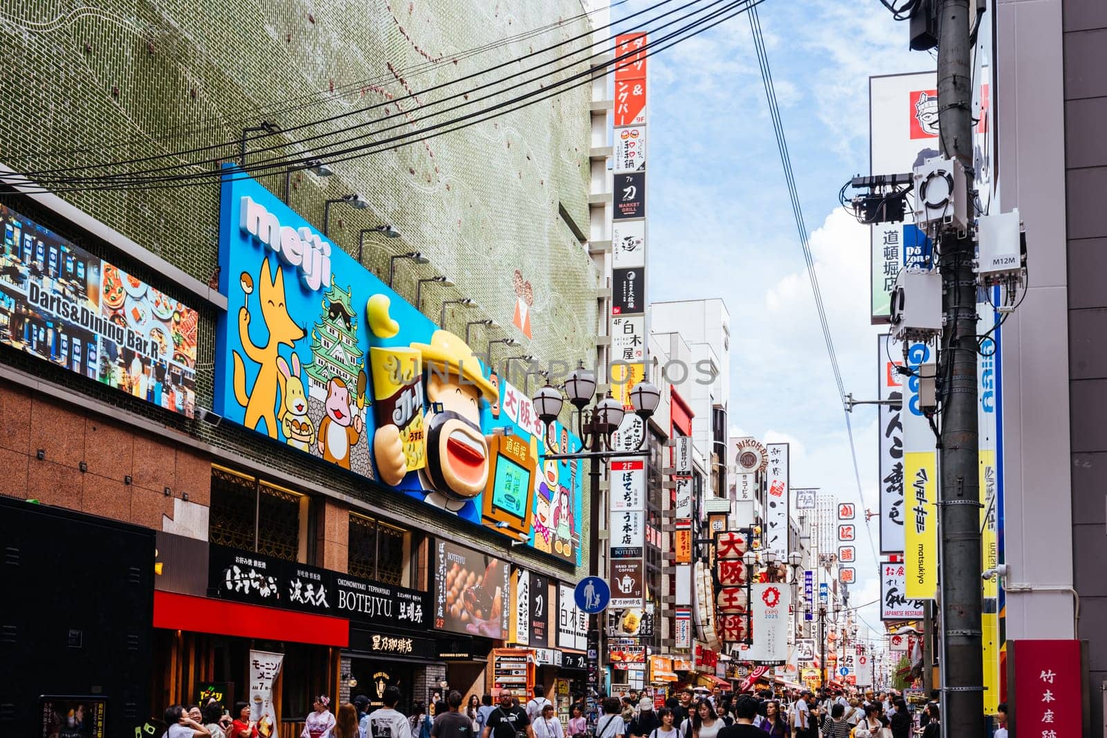 OSAKA, JAPAN - SEPTEMBER 24 2024: Osaka's famous Dotonbori area with many restaurants and iconic food signage at dusk in Osaka, Japan