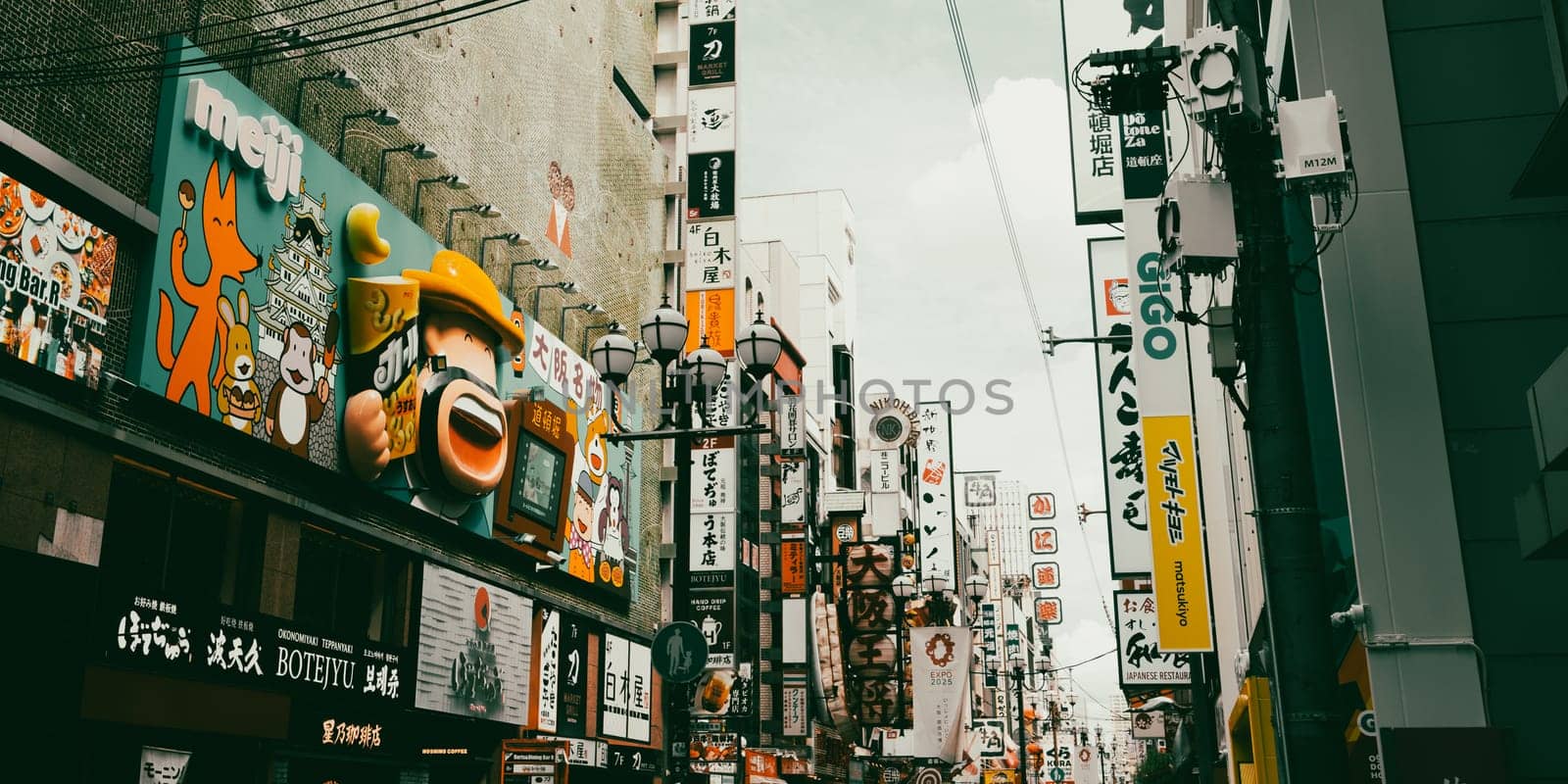 OSAKA, JAPAN - SEPTEMBER 24 2024: Osaka's famous Dotonbori area with many restaurants and iconic food signage at dusk in Osaka, Japan