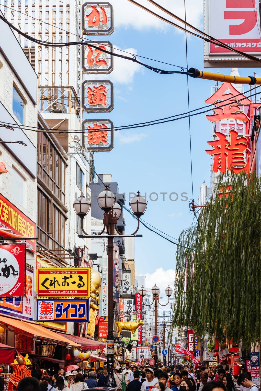 OSAKA, JAPAN - SEPTEMBER 24 2024: Osaka's famous Dotonbori area with many restaurants and iconic food signage at dusk in Osaka, Japan