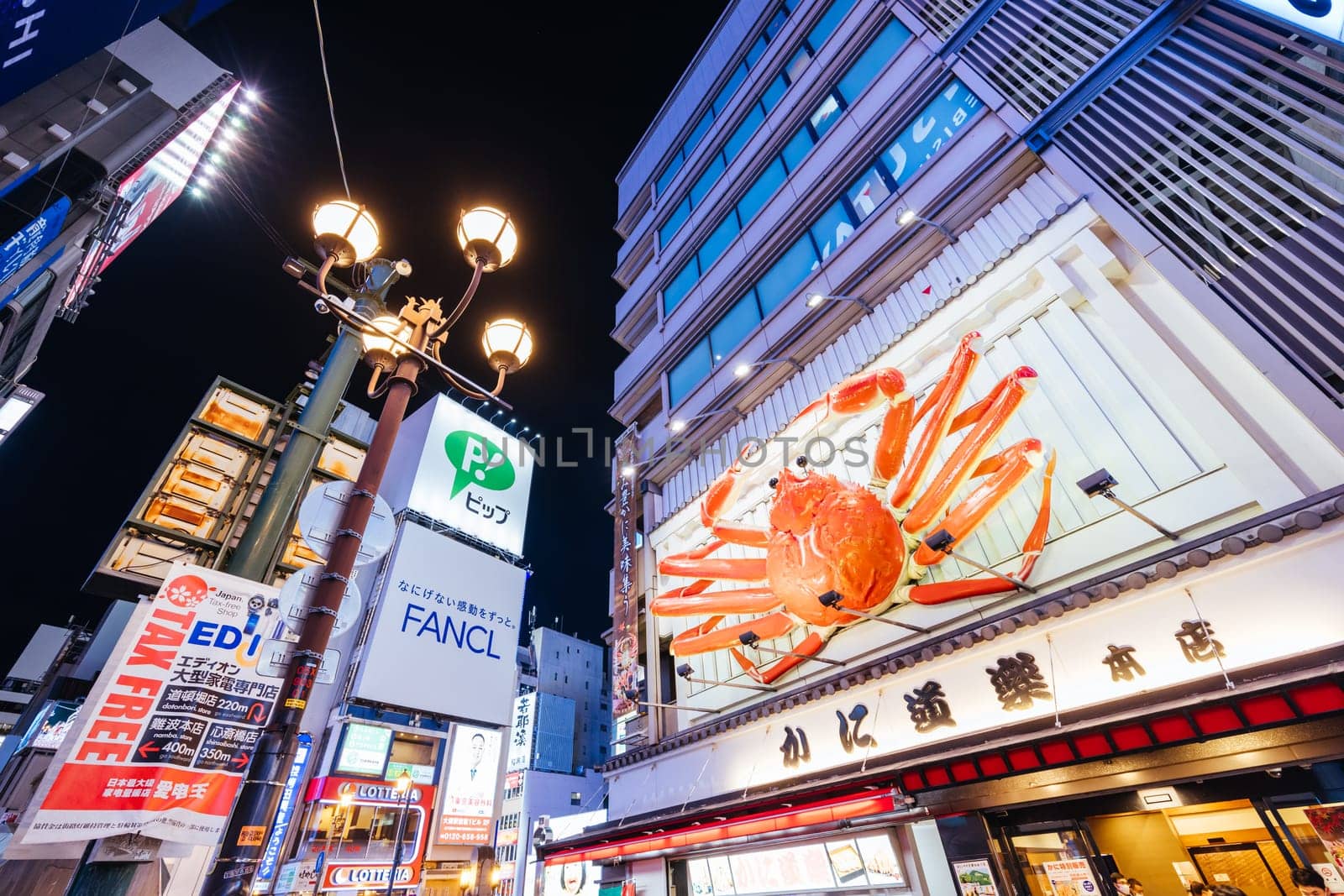 OSAKA, JAPAN - SEPTEMBER 24 2024: Osaka's famous Dotonbori area with many restaurants and iconic food signage, including moving lobsters in Osaka, Japan