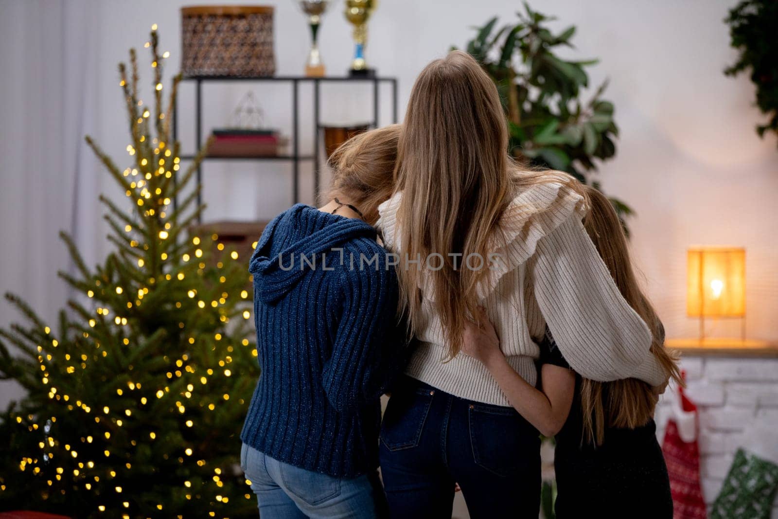 A heartwarming family moment by the beautifully decorated Christmas tree, embodying love and togetherness