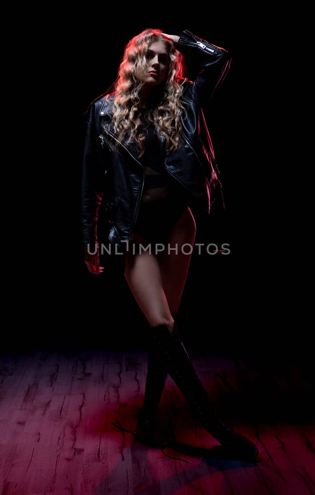 A truly striking fashion pose that vividly showcases an edgy and bold style against a dark backdrop environment