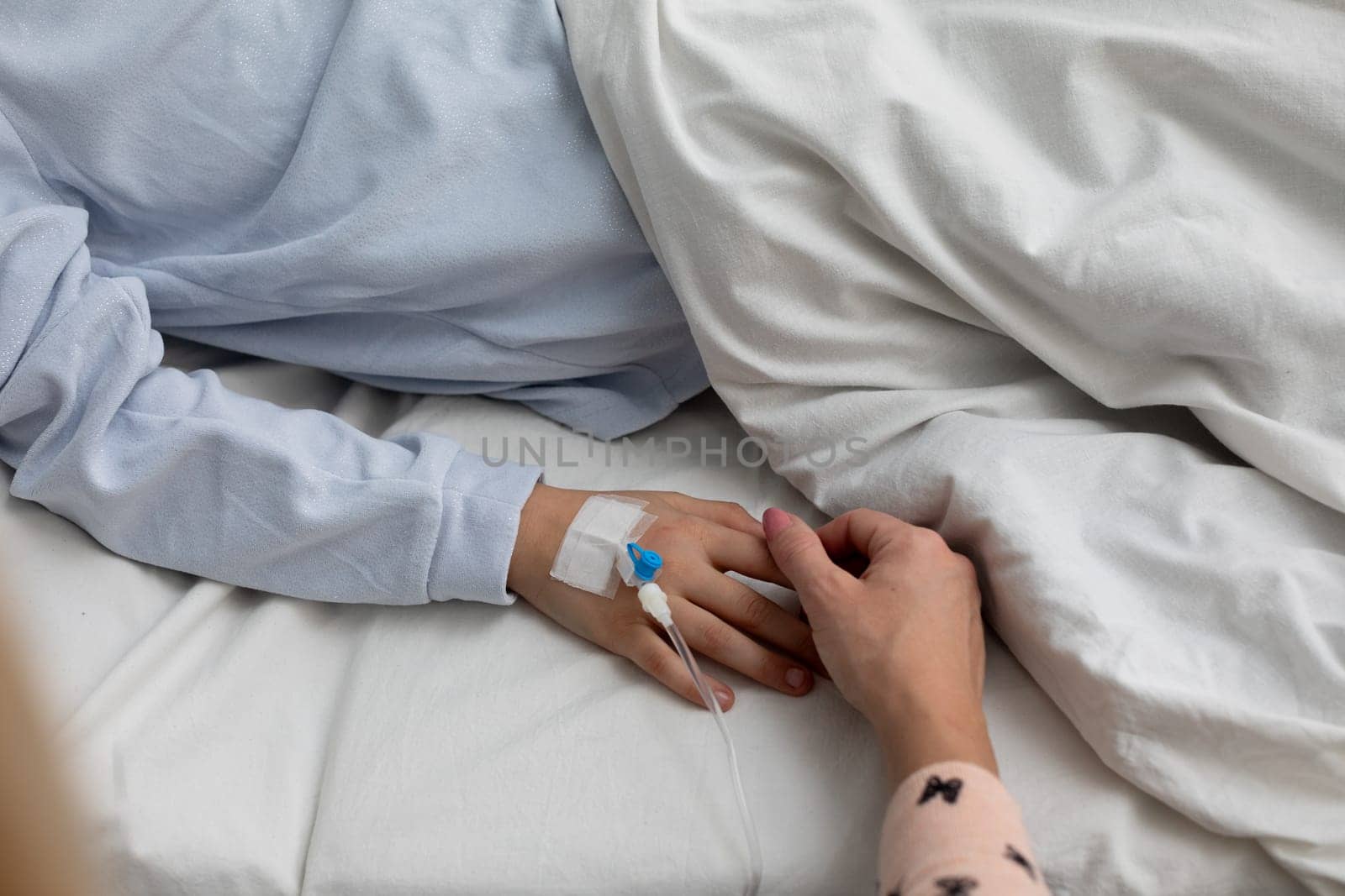 A soothing and comforting scene unfolds in a hospital, beautifully depicting connection and care through handholding