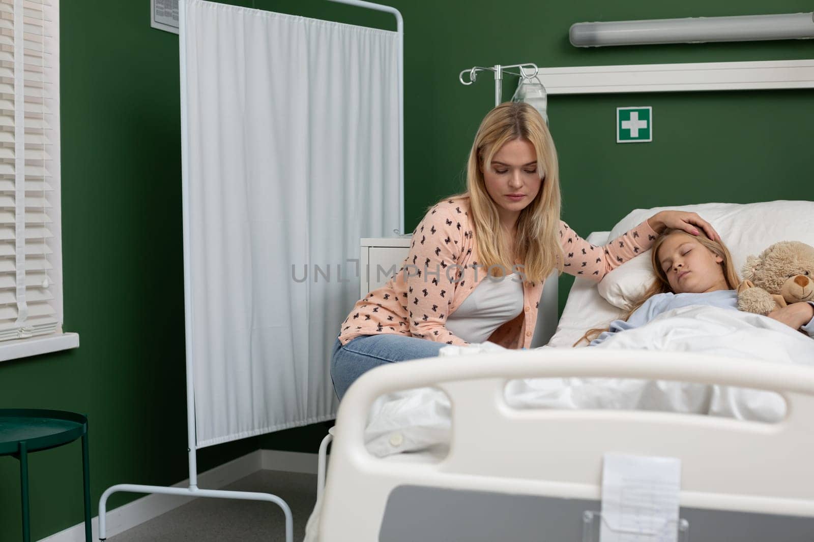 A devoted mother tirelessly cares for her sick child in the hospital, showcasing immense love and unwavering support