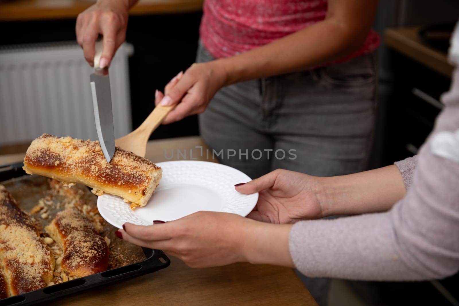 A joyful scene depicting the delightful experience of serving a homemade cake in a cozy and inviting kitchen