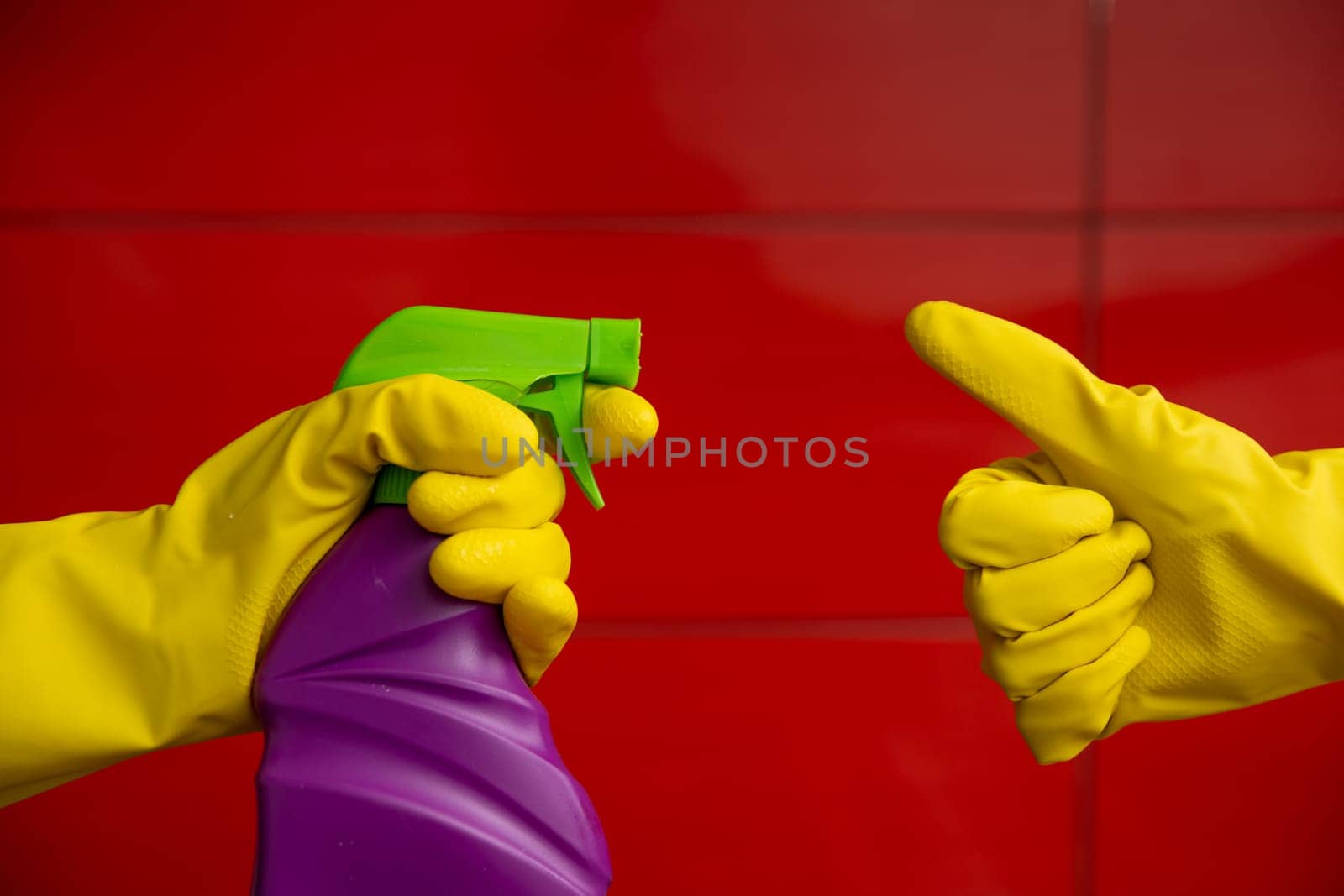 Brightly colored cleaning spray with gloves, perfect for home cleaning tasks and maintaining hygiene.