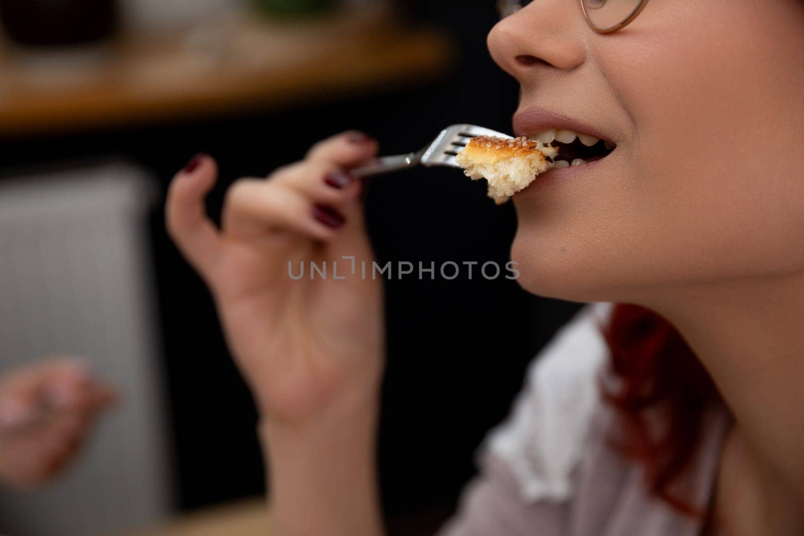 A closeup of a woman relishing and savoring her delicious dessert, capturing a delightful moment of culinary pleasure