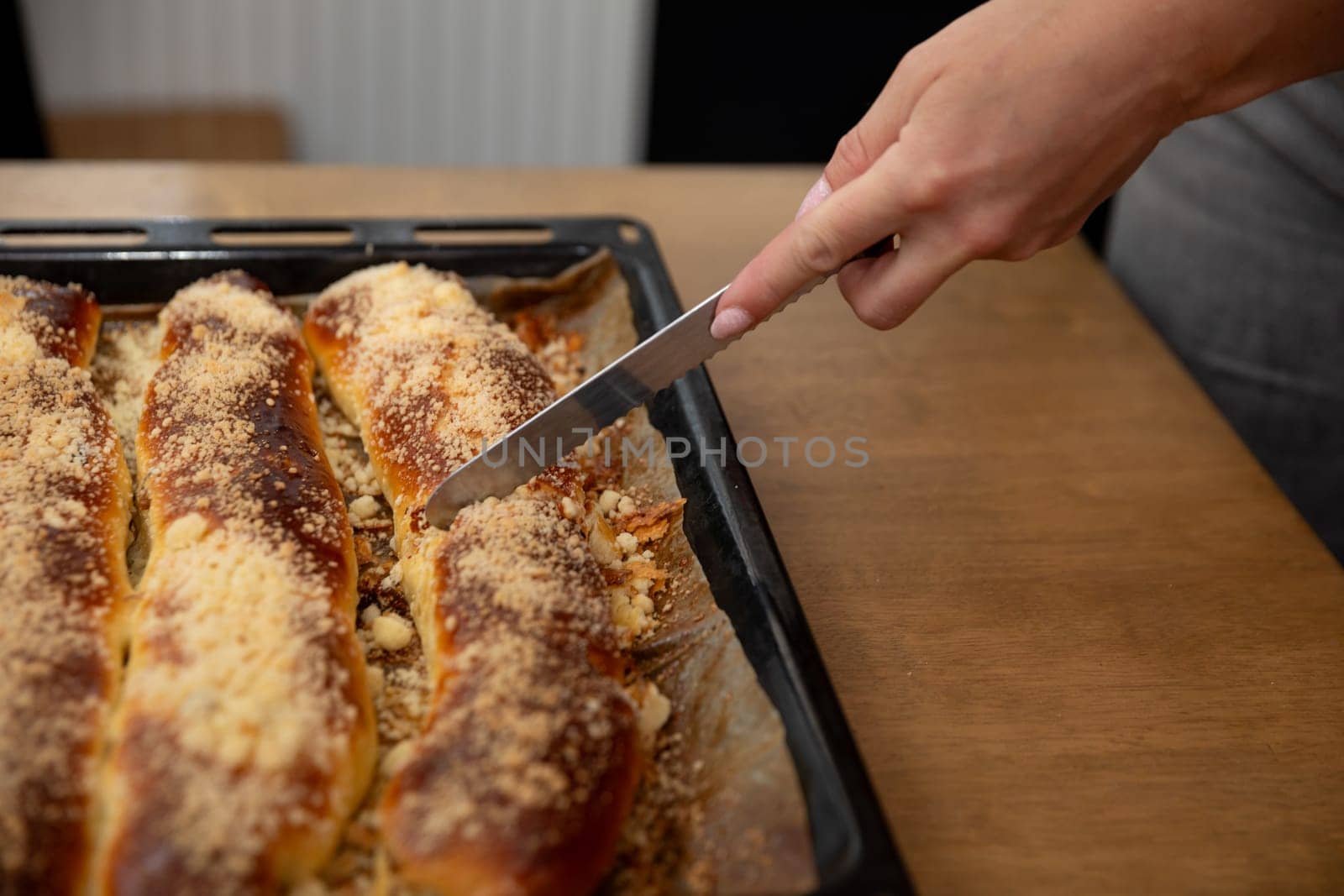 A freshly baked artisan bread loaf is sliced on a wooden board, showcasing its golden crust and delicious texture