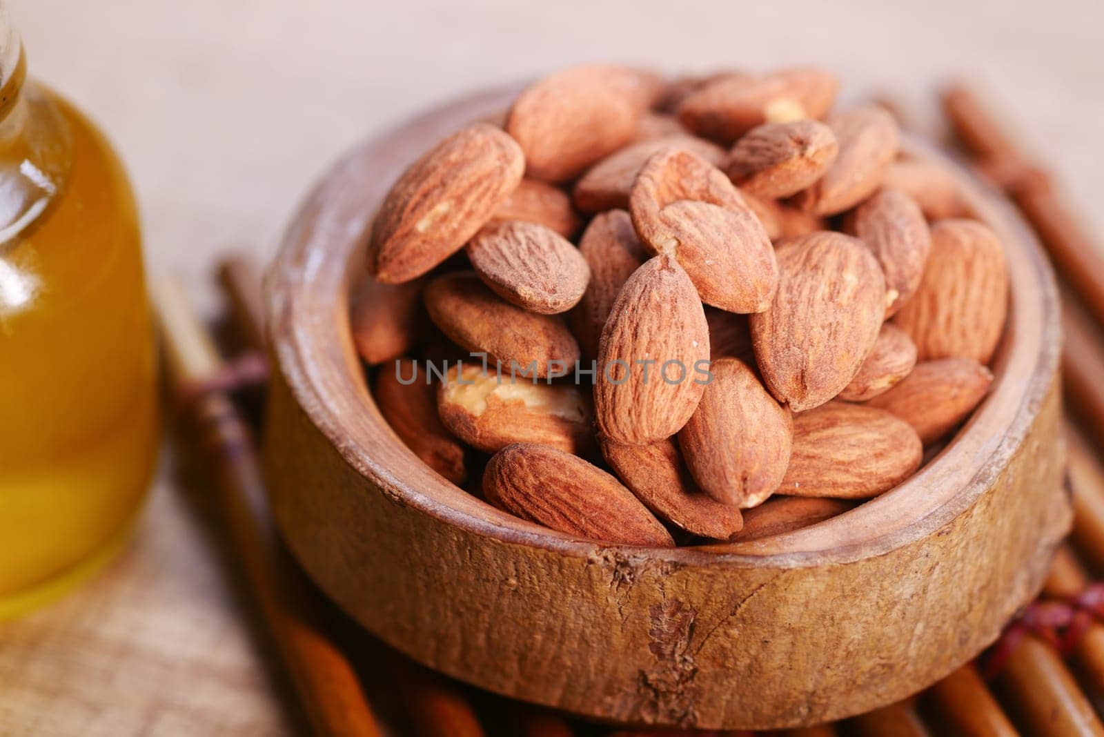 almond oils and fresh nuts on table ,