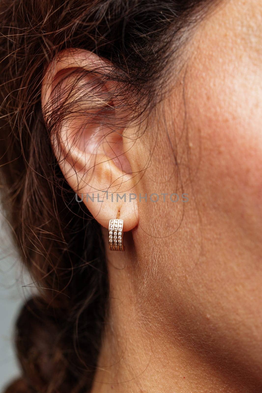 Close-up view of a woman wearing elegant diamond earrings