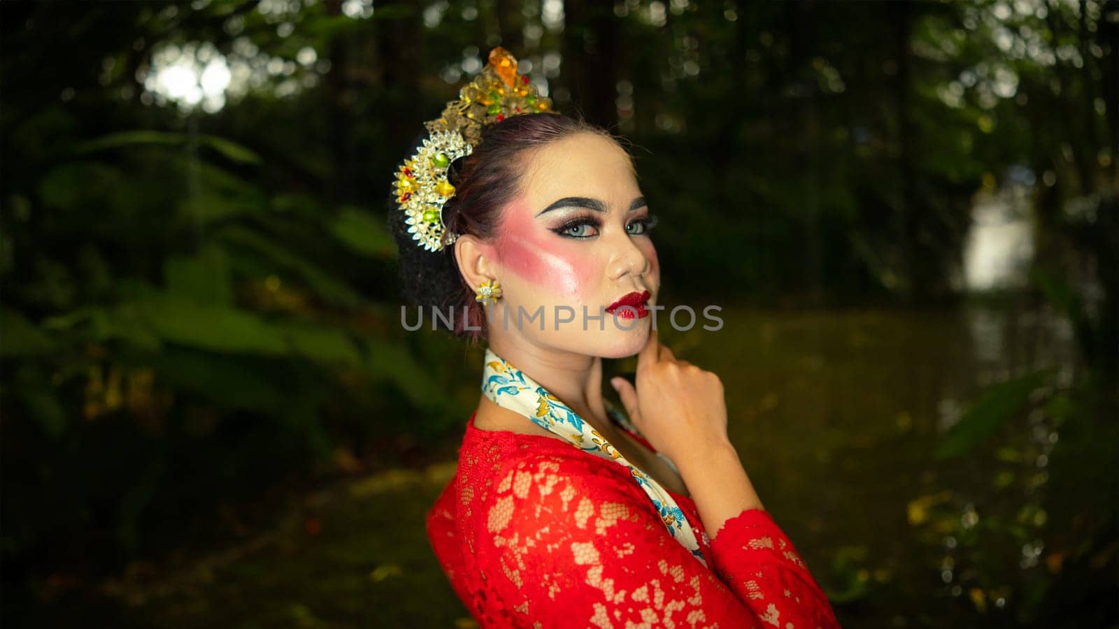 a traditional dancer called ronggeng stands with an expression full of beauty and beauty in a magical forest in the afternoon