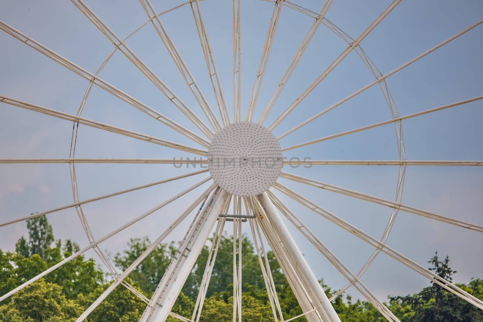 Center of ferris wheel with glowing dots in the middle at sunny afternoon