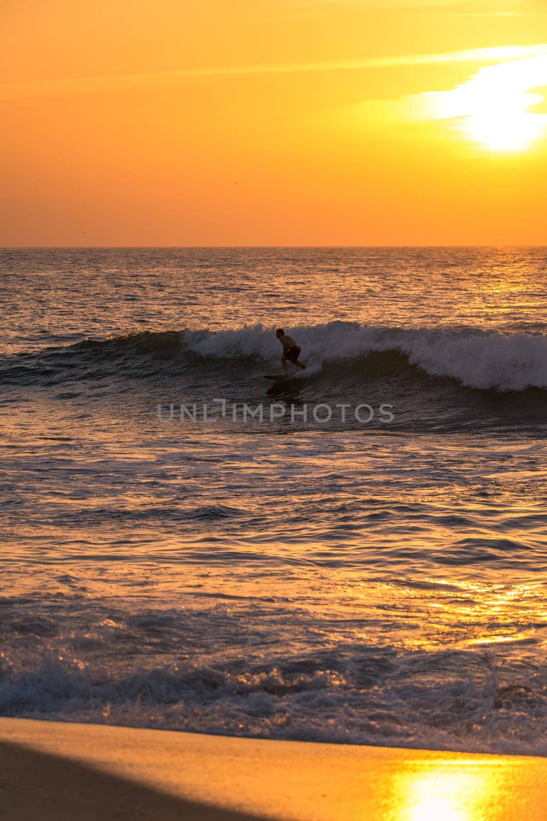 Surfer riding waves in Furadouro Beach by homydesign