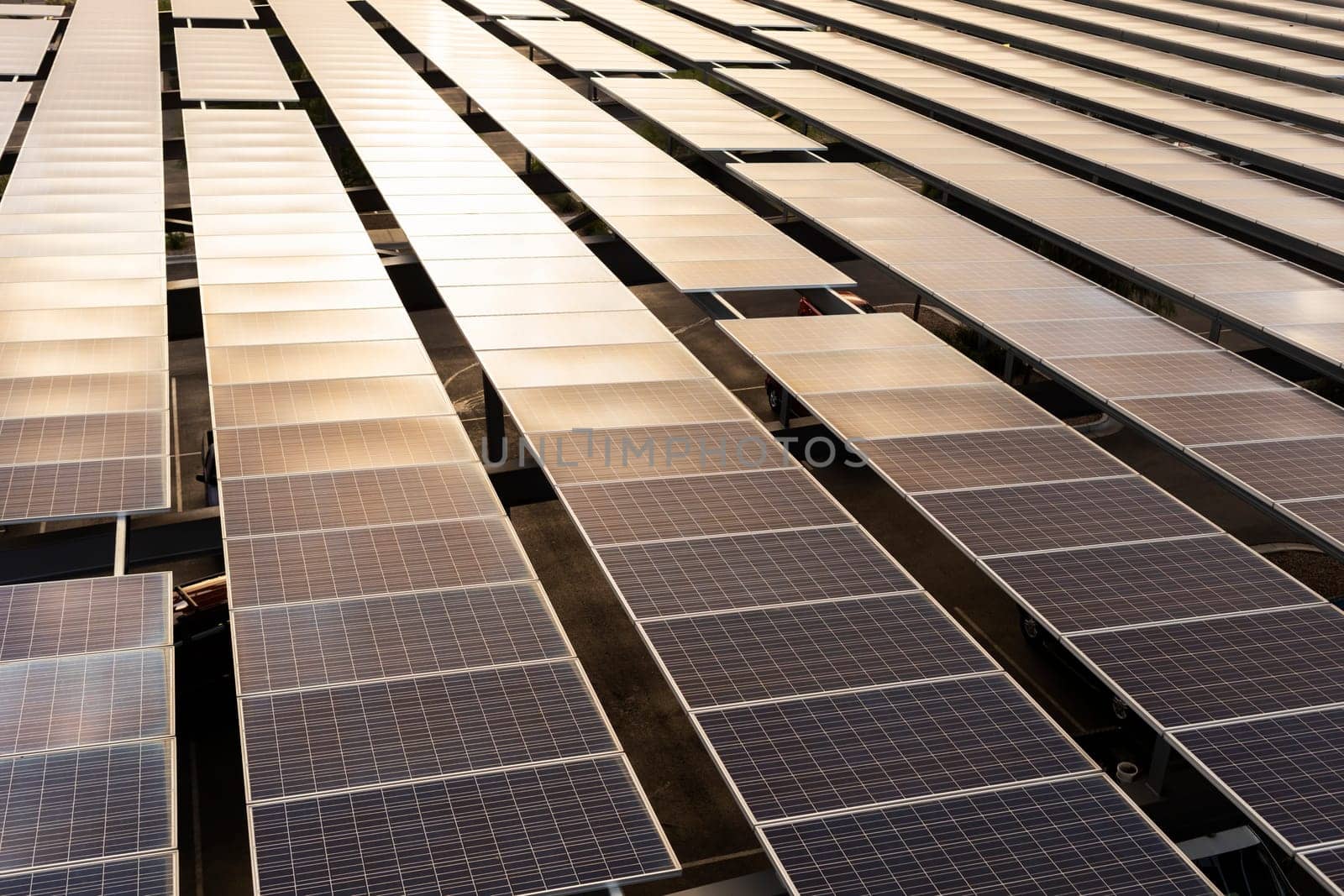 Flatly Solar Panels Or Solar Cell with Sun Reflection above Parking Places Outdoor, Renewable Electrical Energy Production. Green Clean Alternative Power. Photovoltaic Modules. Horizontal Plane.