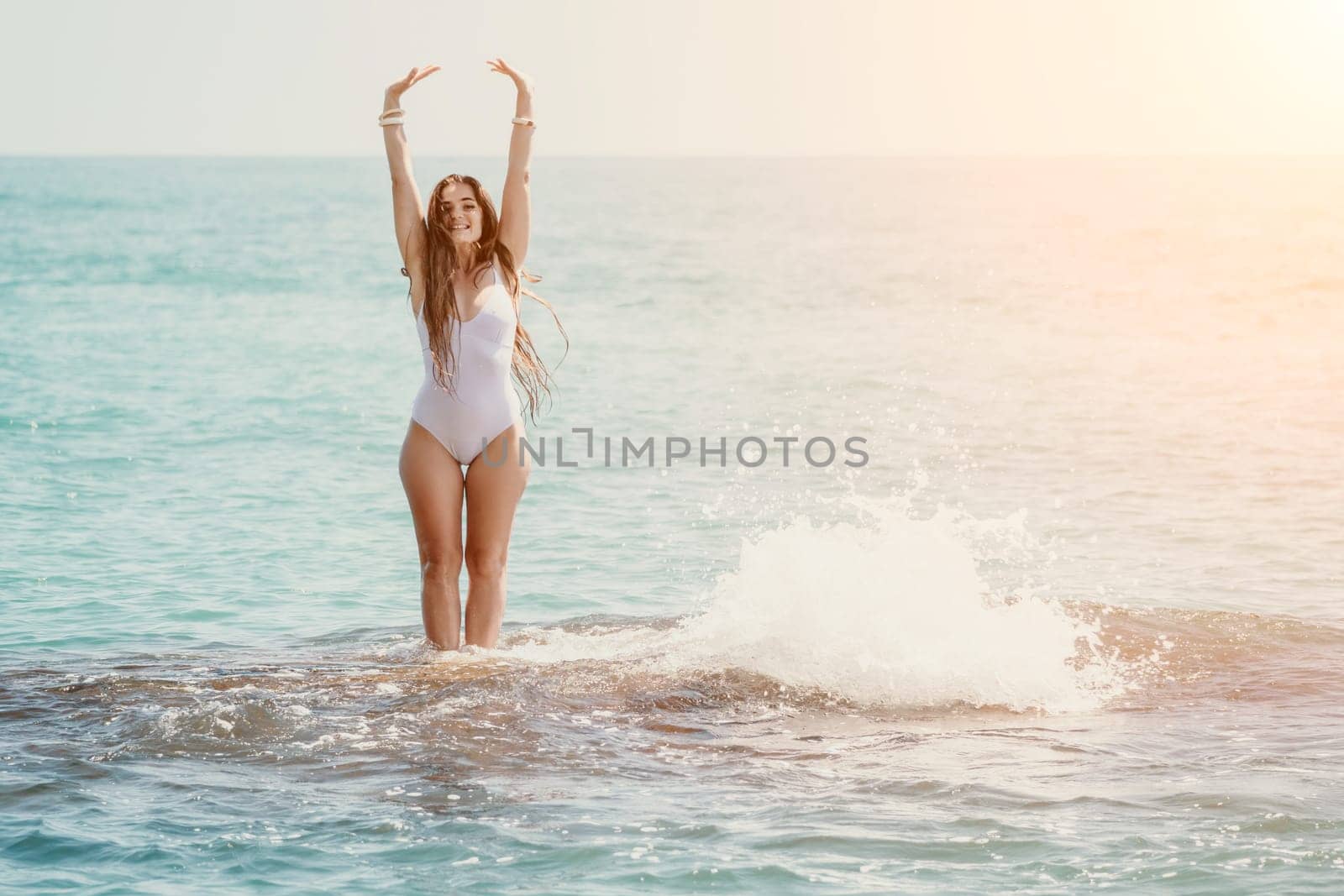 Woman sea yoga. Back view of free calm happy satisfied woman with long hair standing on top rock with yoga position against of sky by the sea. Healthy lifestyle outdoors in nature, fitness concept by panophotograph