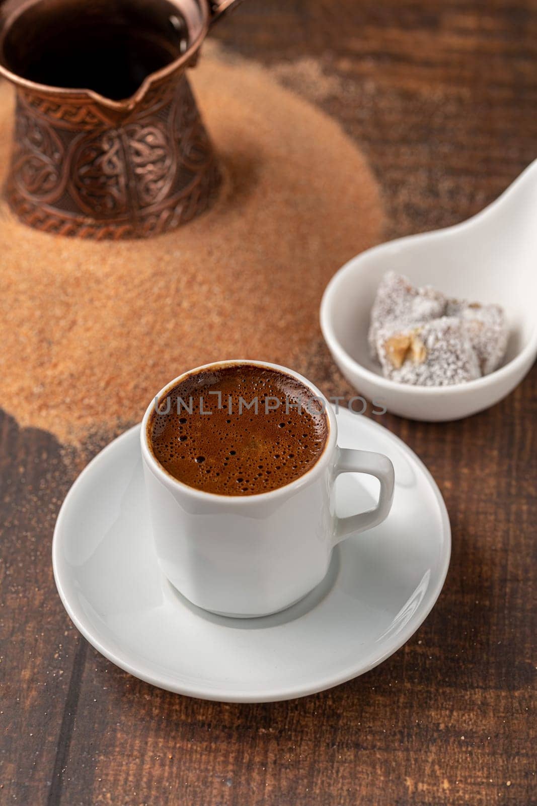 Turkish coffee cooked in hot sand with Turkish delight in a classic coffee cup by Sonat