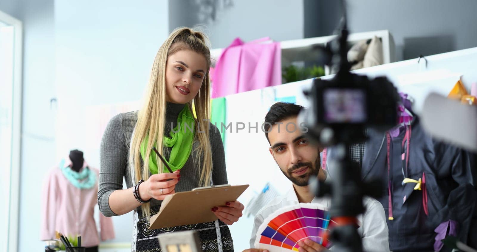 Two young blogger designers are broadcasting on professional camera, talking sharing tips and chatting with subscribers by kuprevich