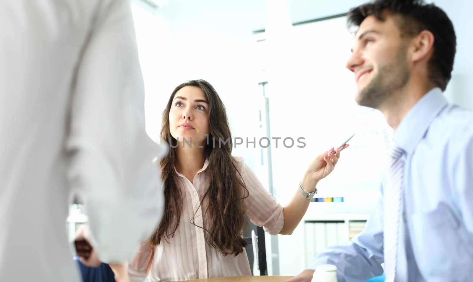 Serious professional female consultant consulting client at meeting. Mentor trains trainee at hiring