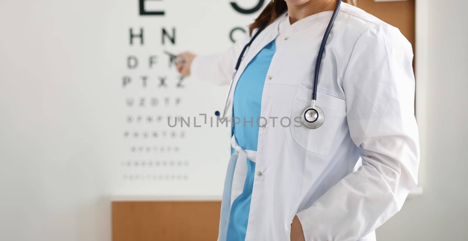 Ophthalmologist standing on background of table measuring vision closeup. Vision check in ophthalmological clinic