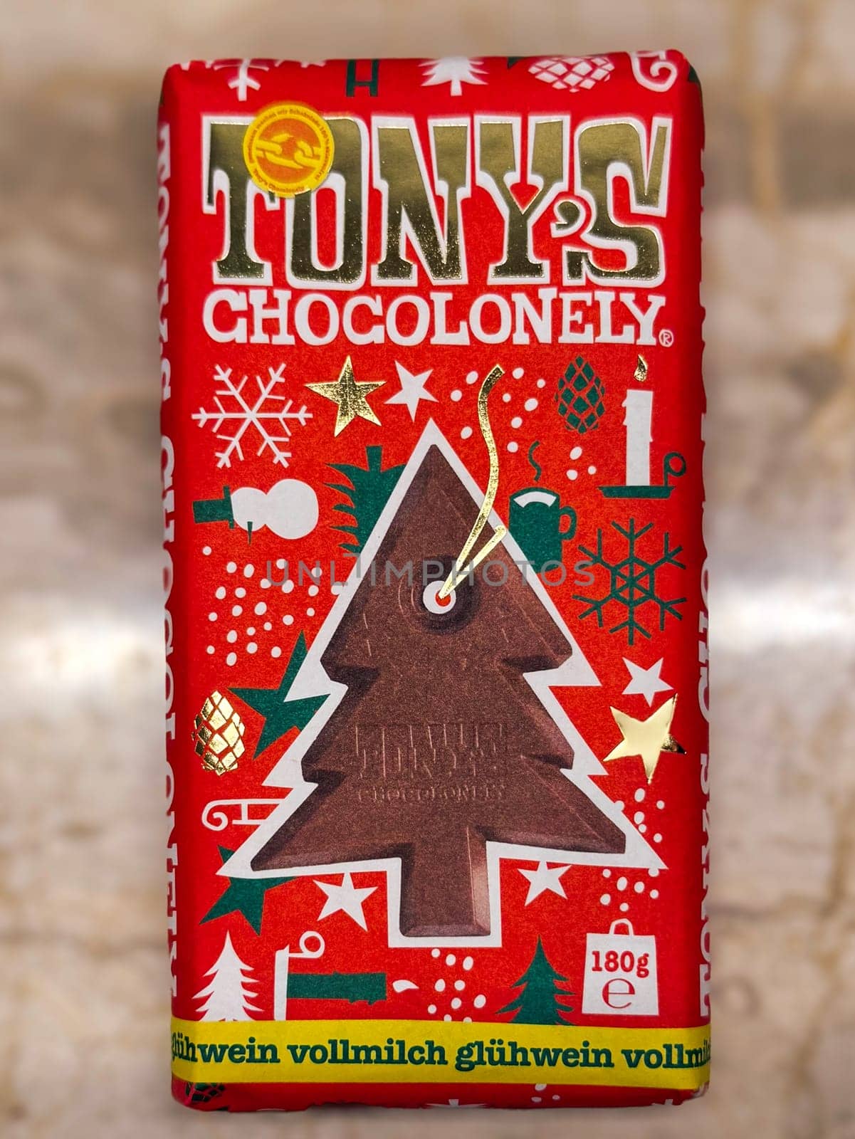Thessaloniki, Greece - December 12 2024: Tony’s Chocolonely Festive Chocolate Bar with Holiday Decoration Featuring Christmas Tree Design.