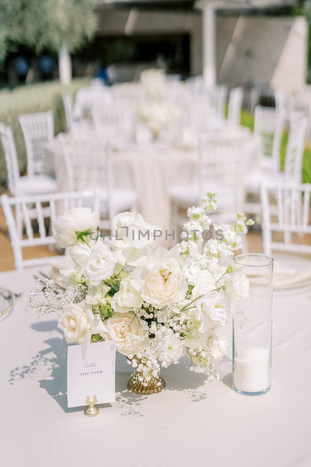 Name plate on a stand near a bouquet of flowers on a festive table. High quality photo
