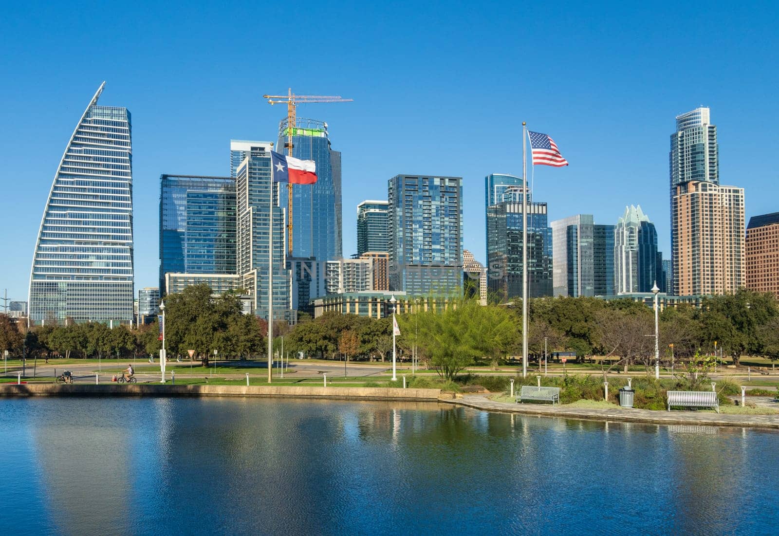 Modern apartment buildings and offices by the Colorado River in cityscape skyline of Austin Texas across Palmer Lake in December