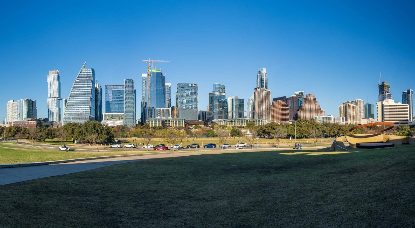 Modern apartment buildings and offices by the Colorado River in cityscape skyline of Austin Texas from the Town Park