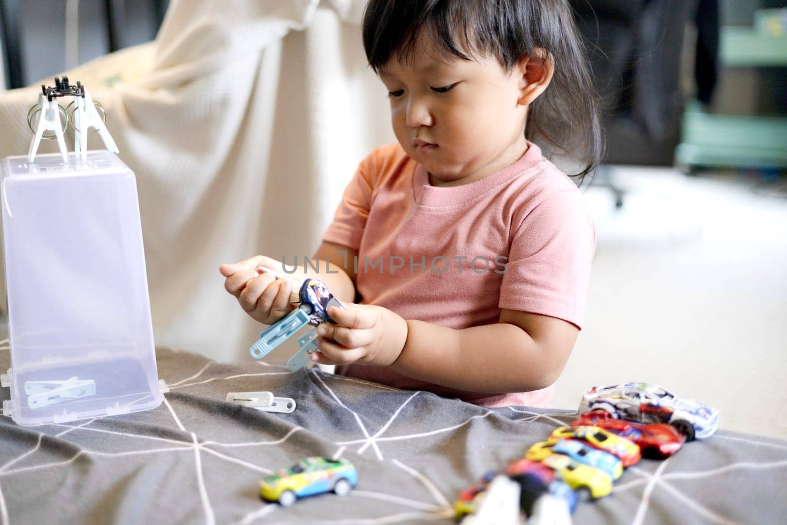 Little Child Playing With Clothespins. Sensory development. Child development concept.