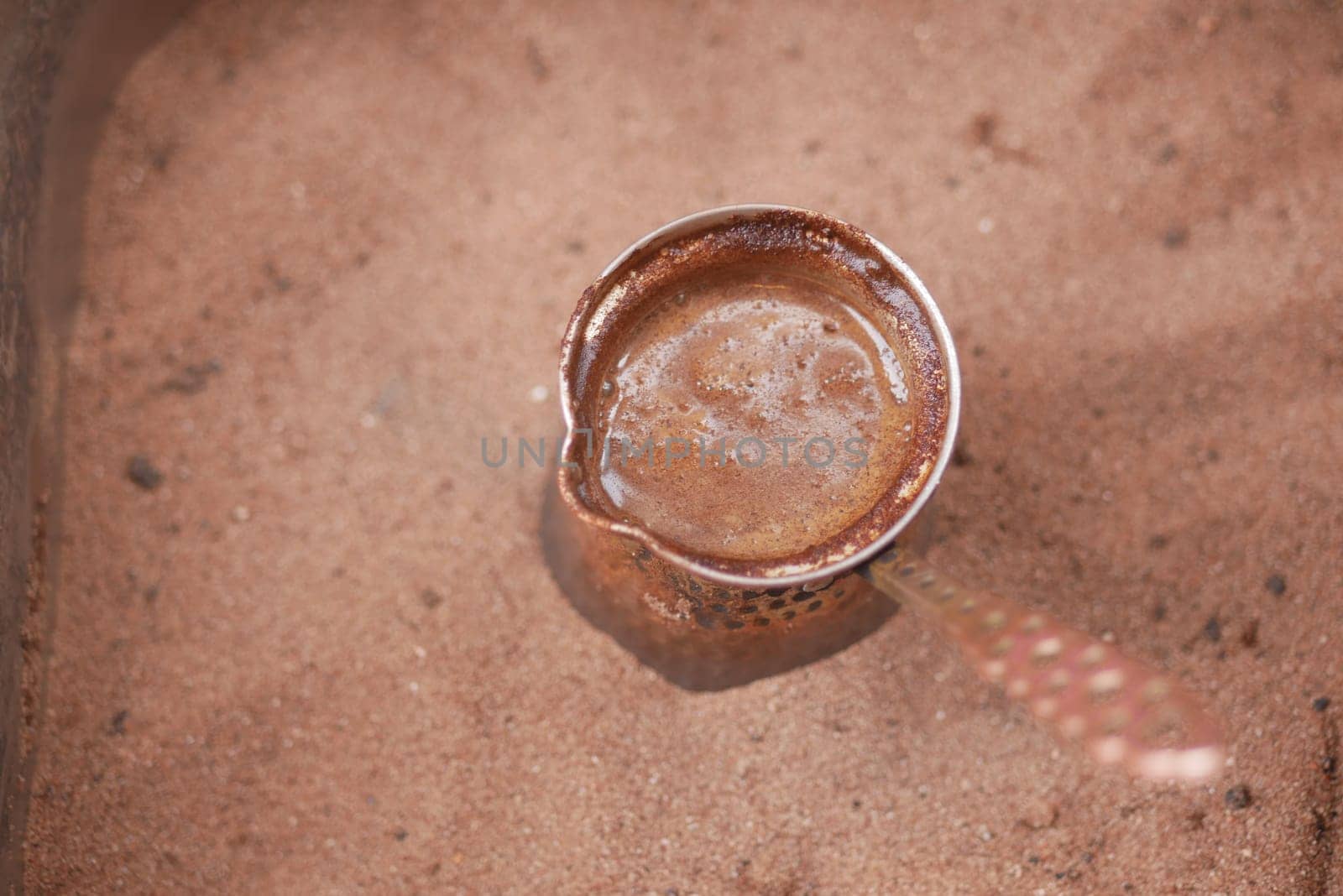 top view of making traditional turkish coffee on sand
