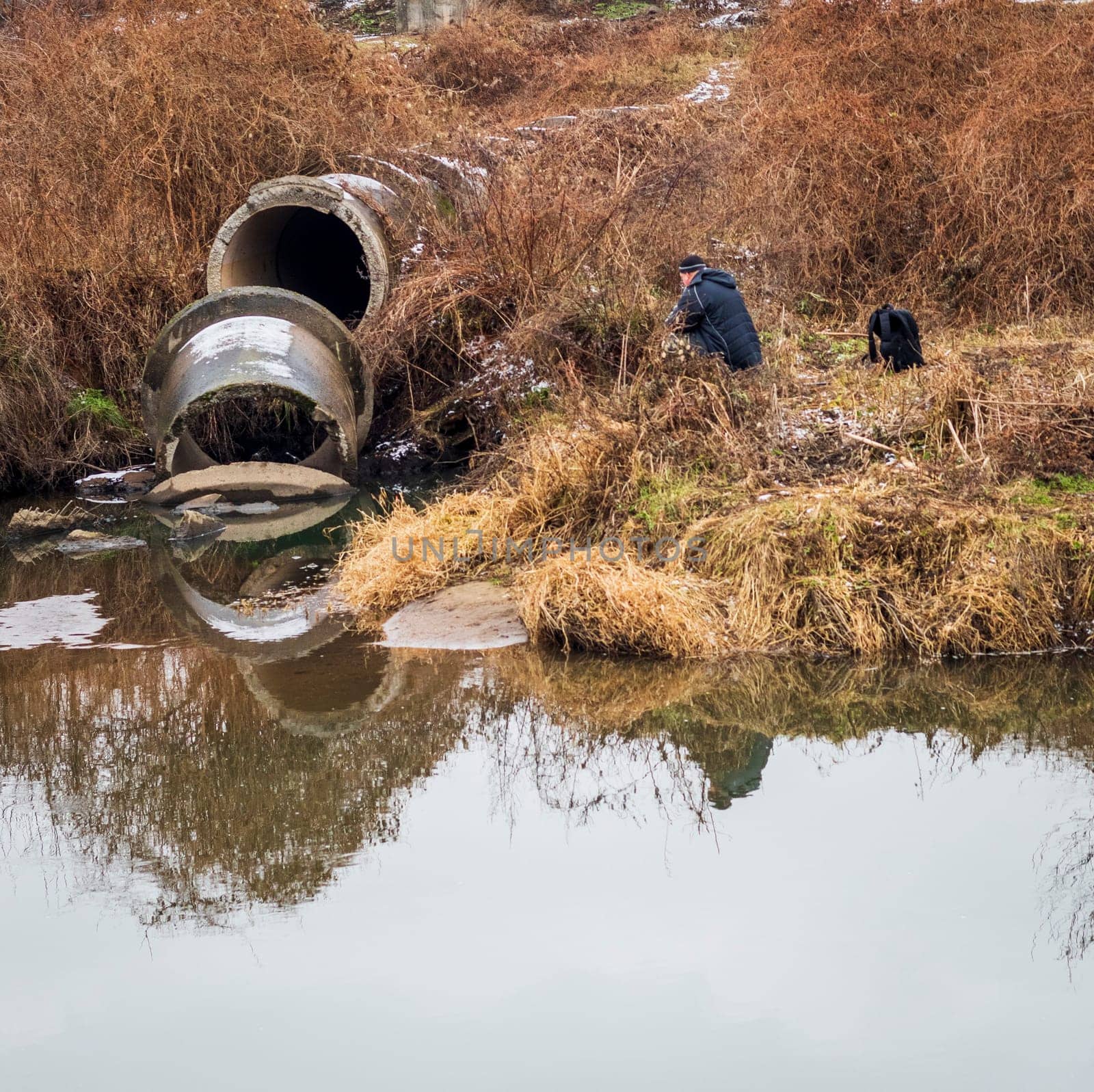 Shot of the man fishing on the winter river