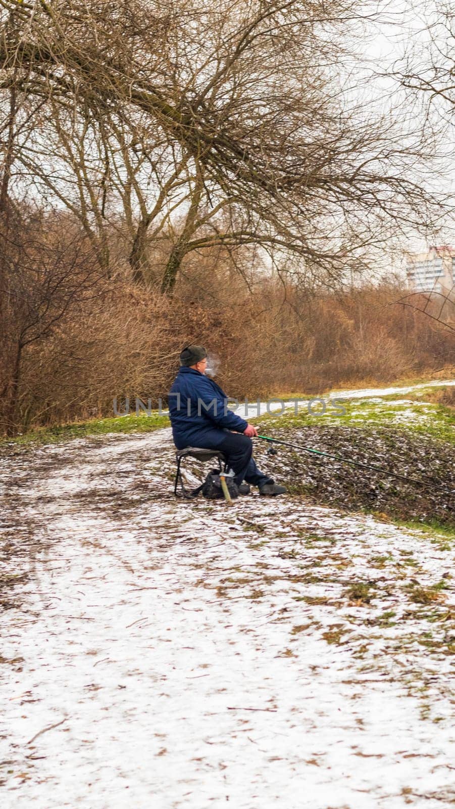 Shot of the man fishing on the winter river